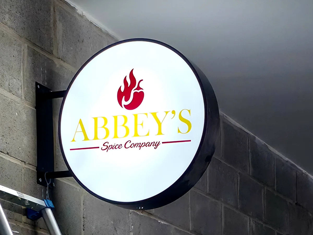 Illuminated projecting shop sign installed for a business in Rutherglen
