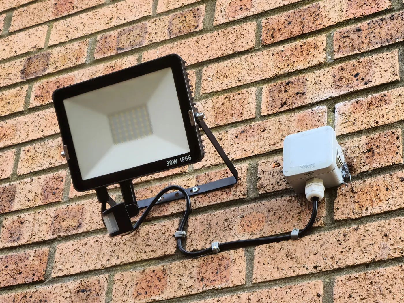 Outdoor LED floodlight and weatherproof junction box installed